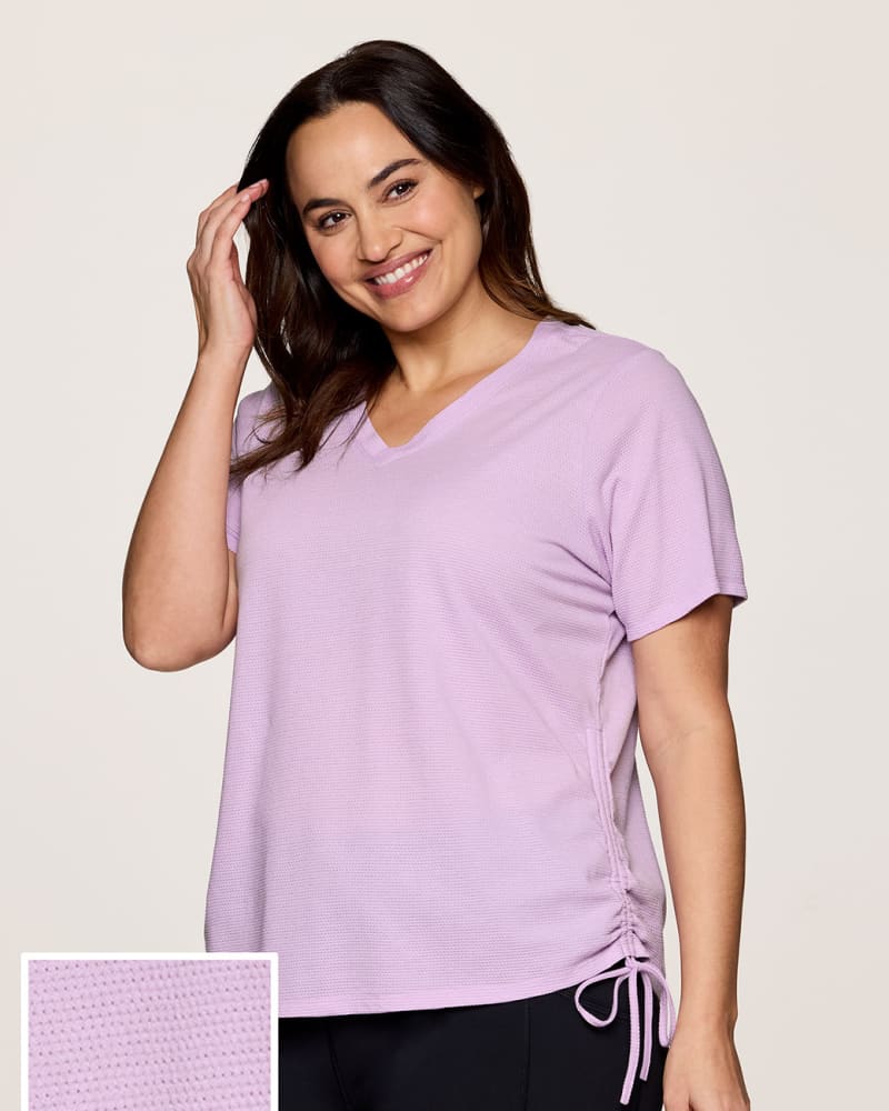 Front of a model wearing a size 1X Plus All In Ruched Tee in Light Purple by RBX Active. | dia_product_style_image_id:331589
